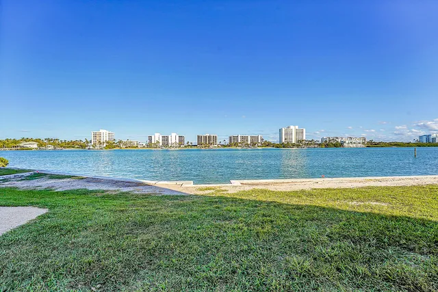 a view of a park with multi story residential apartment building in the back