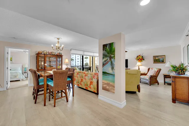 a view of a dining room with furniture and chandelier