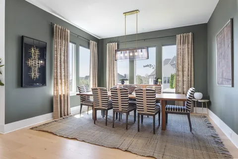 a living room with furniture large window and flat screen tv