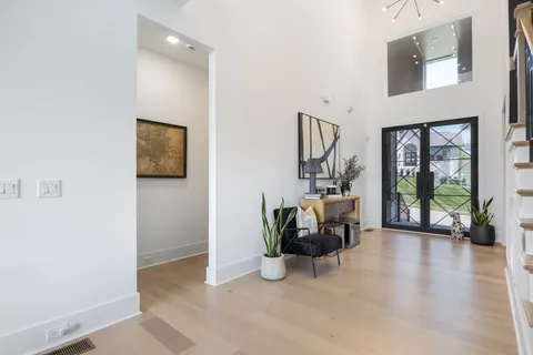 a living room with fireplace furniture and a potted plant