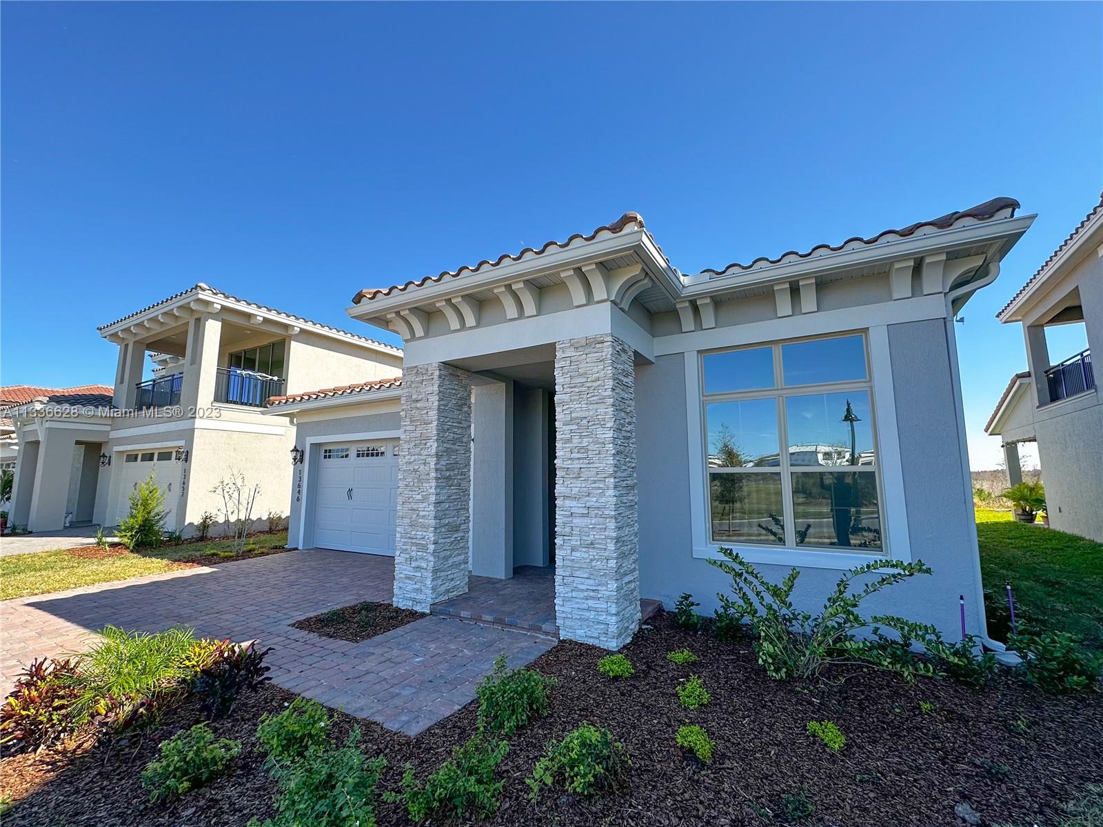 13646 Abberwick Drive Orlando, FL 32832 - Photo 1 of 50 a front view of a house with garden