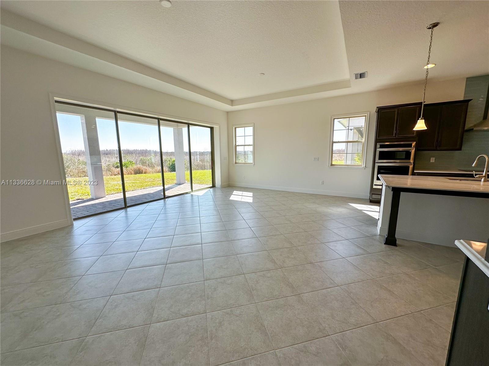 13646 Abberwick Drive Orlando, FL 32832 - Photo 12 of 50 a view of an empty room with a window