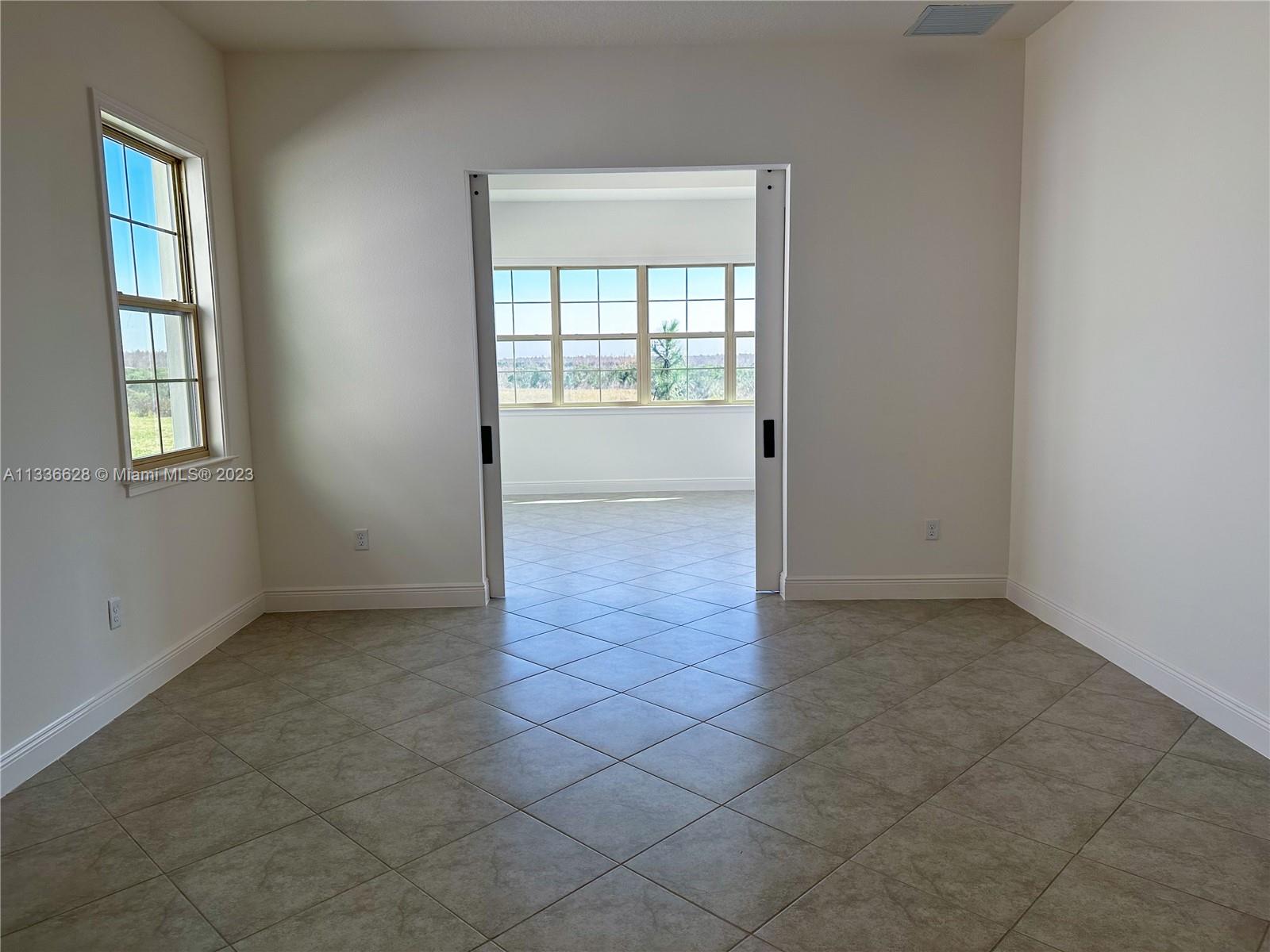 13646 Abberwick Drive Orlando, FL 32832 - Photo 16 of 50 an empty room that has a window
