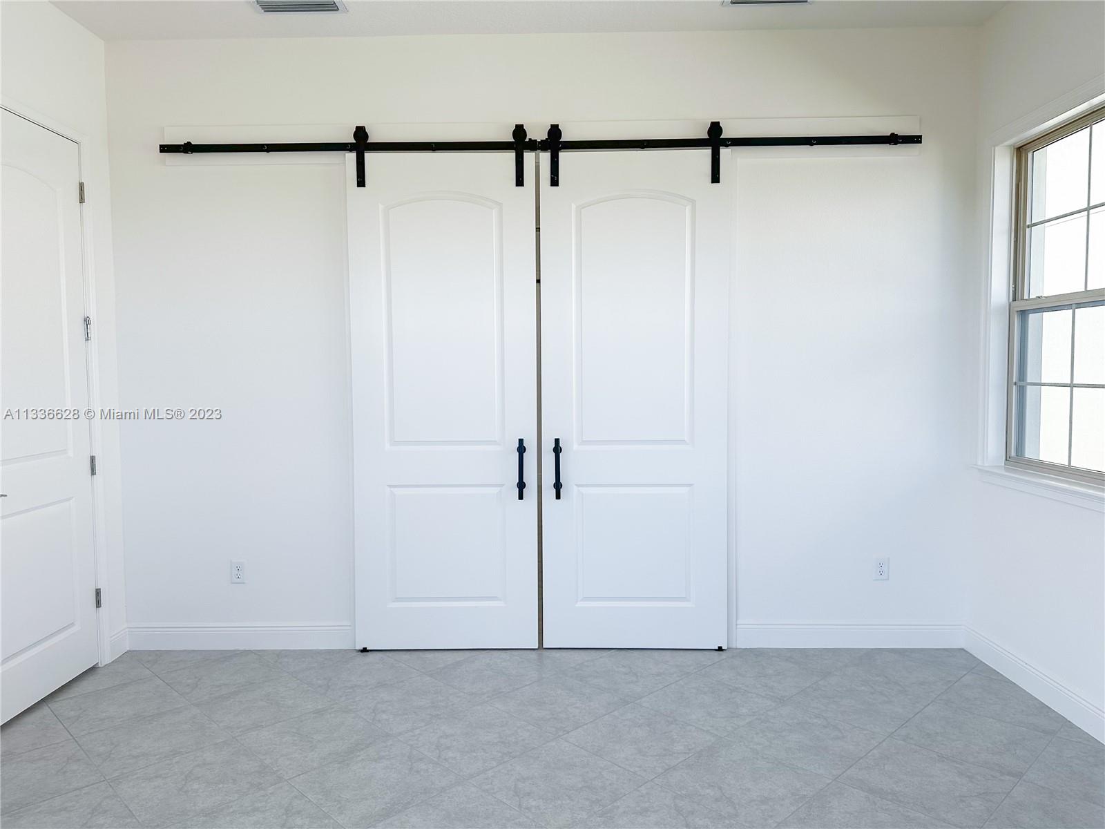 13646 Abberwick Drive Orlando, FL 32832 - Photo 5 of 50 a view of a room with racks on the wall