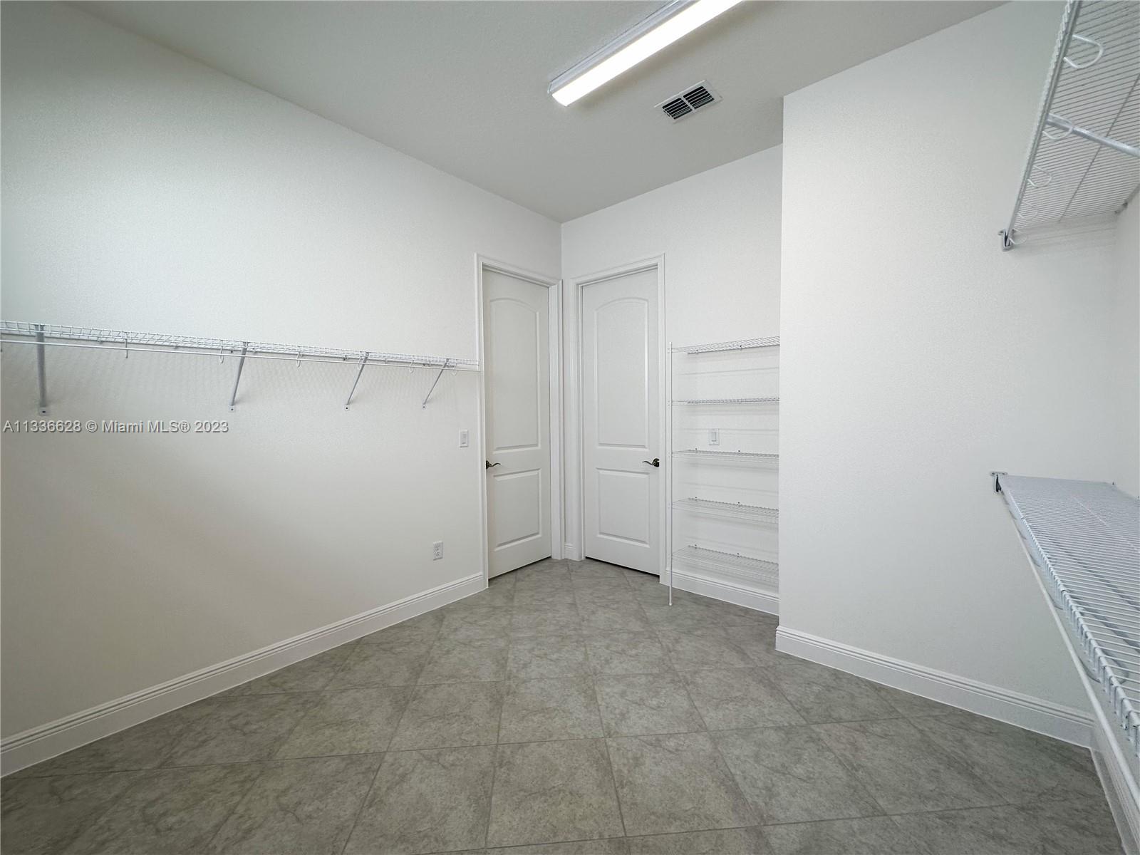 13646 Abberwick Drive Orlando, FL 32832 - Photo 9 of 50 an empty room with cabinet