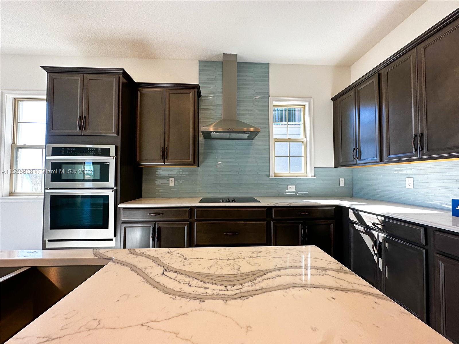 13646 Abberwick Drive Orlando, FL 32832 - Photo 10 of 50 a kitchen with a sink and refrigerator