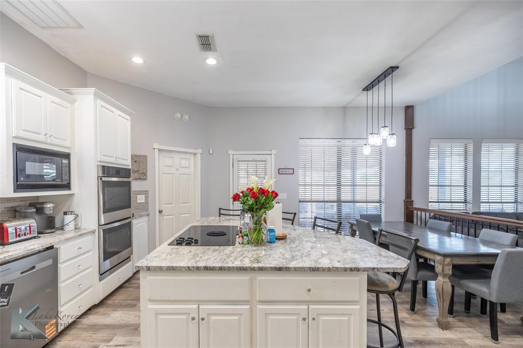 1834 Marathon Court Abilene, TX 79601 - Photo 11 of 39 a kitchen with stainless steel appliances granite countertop a kitchen island a stove and a sink