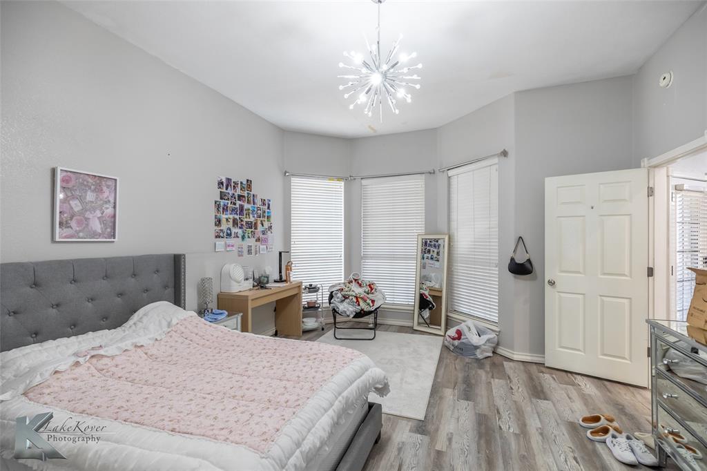 1834 Marathon Court Abilene, TX 79601 - Photo 14 of 39 a bed room with a bed and a chandelier