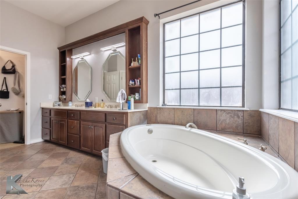 1834 Marathon Court Abilene, TX 79601 - Photo 17 of 39 a bathroom with a tub sink and mirror