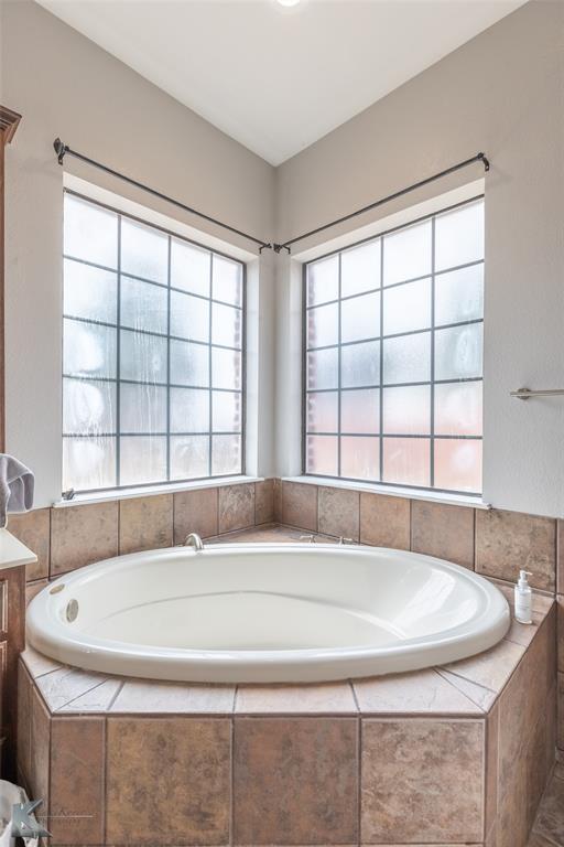 1834 Marathon Court Abilene, TX 79601 - Photo 18 of 39 a bathroom with a granite countertop sink and a large window