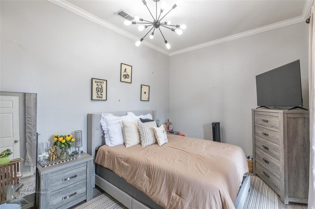 1834 Marathon Court Abilene, TX 79601 - Photo 19 of 39 a bedroom with a bed and a flat tv screen on dresser