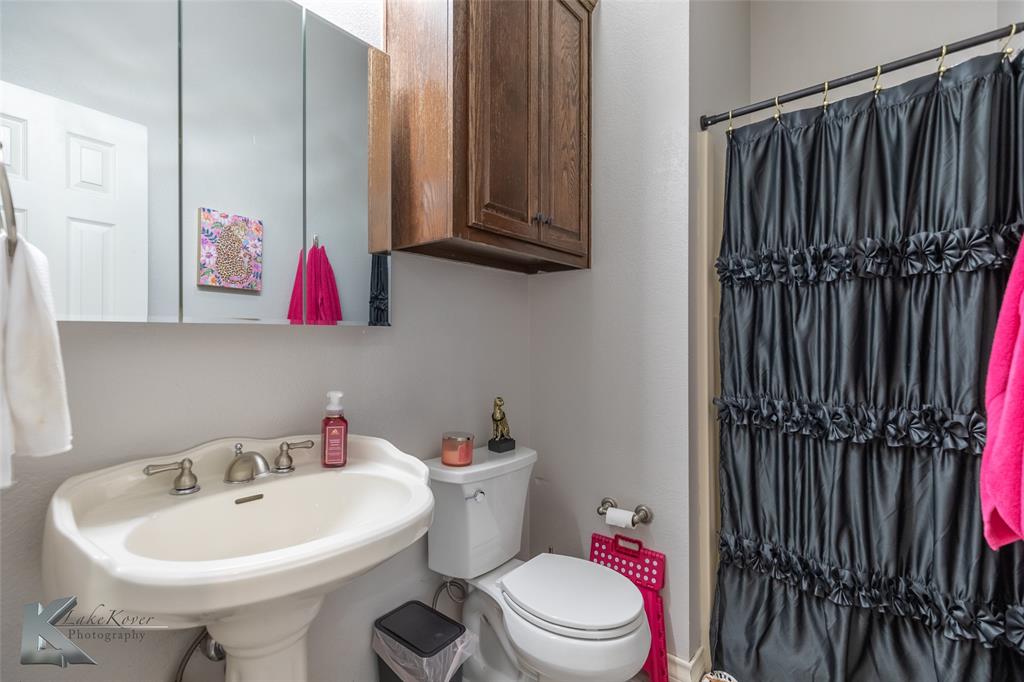 1834 Marathon Court Abilene, TX 79601 - Photo 25 of 39 a bathroom with a sink toilet and mirror