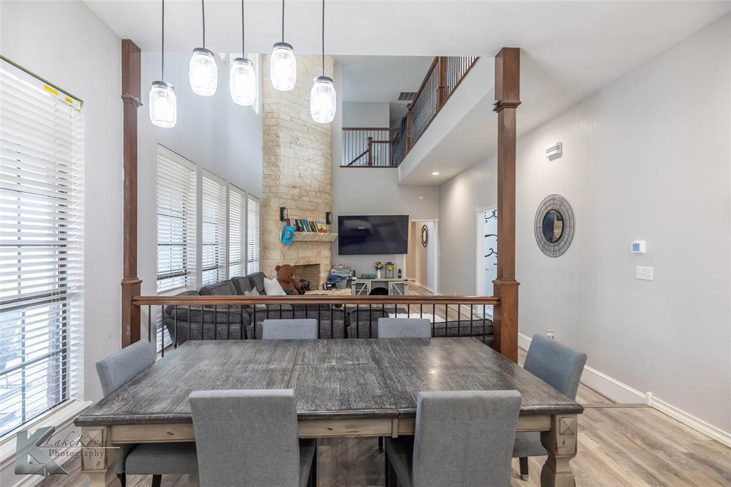 1834 Marathon Court Abilene, TX 79601 - Photo 8 of 39 a view of dining room and livingroom with furniture wooden floor a rug a painting and a chandelier