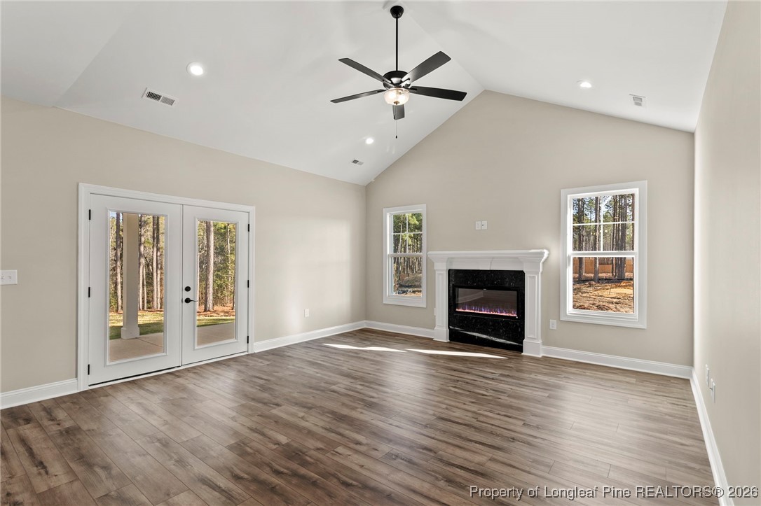 940 Rhum Drive Fayetteville, NC 28311 - Photo 18 of 45 a view of a livingroom with a fireplace a ceiling fan and windows