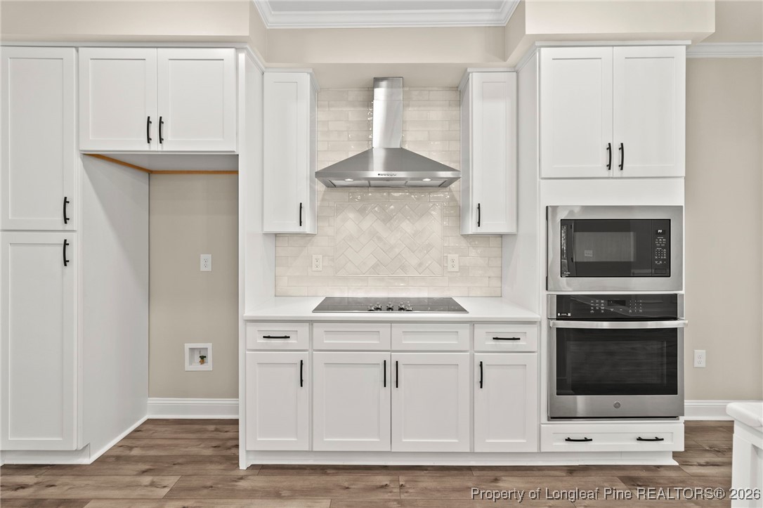 940 Rhum Drive Fayetteville, NC 28311 - Photo 23 of 45 a kitchen with stainless steel appliances granite countertop a stove and white cabinets