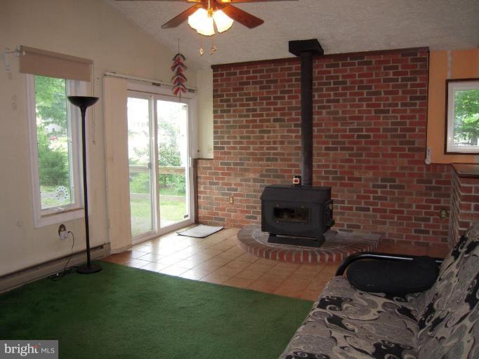 313 Londontown Road Edgewater, MD 21037 - Photo 6 of 25 a living room with furniture and a fireplace