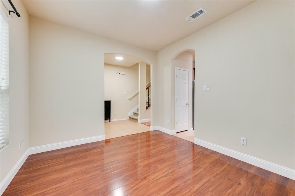 4521 Indian Paint Way Denton, TX 76208 - Photo 15 of 36 a view of empty room with wooden floor and windows
