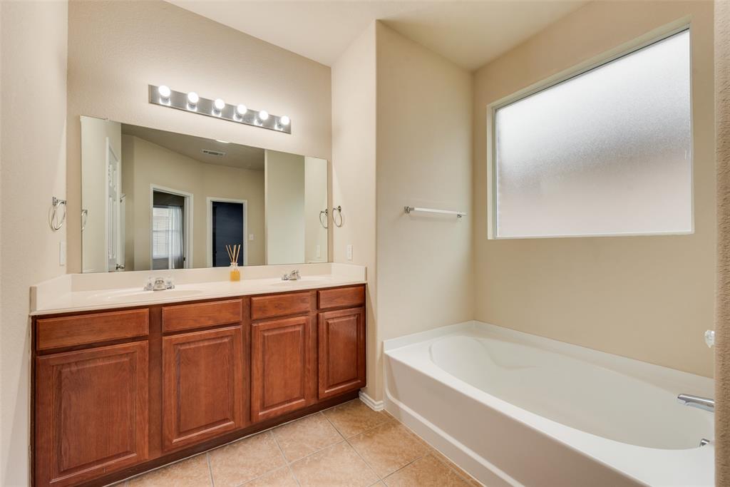 4521 Indian Paint Way Denton, TX 76208 - Photo 20 of 36 a spacious bathroom with a tub sink and mirror