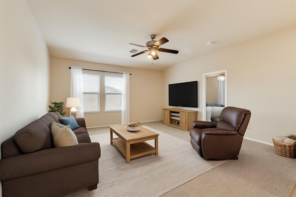 4521 Indian Paint Way Denton, TX 76208 - Photo 23 of 36 a living room with furniture and a flat screen tv