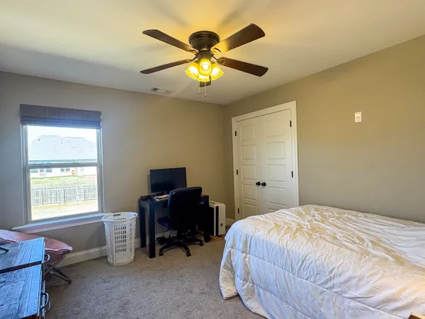 a living room with furniture a fireplace a flat screen tv and kitchen view