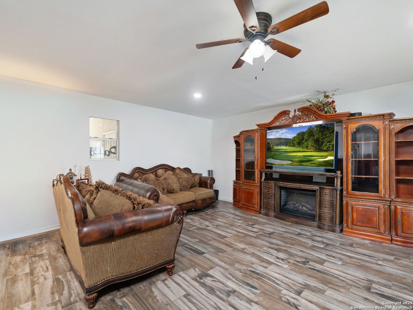 6472 Whitby Road San Antonio, TX 78240 - Photo 2 of 23 a living room with furniture a fireplace and a flat screen tv