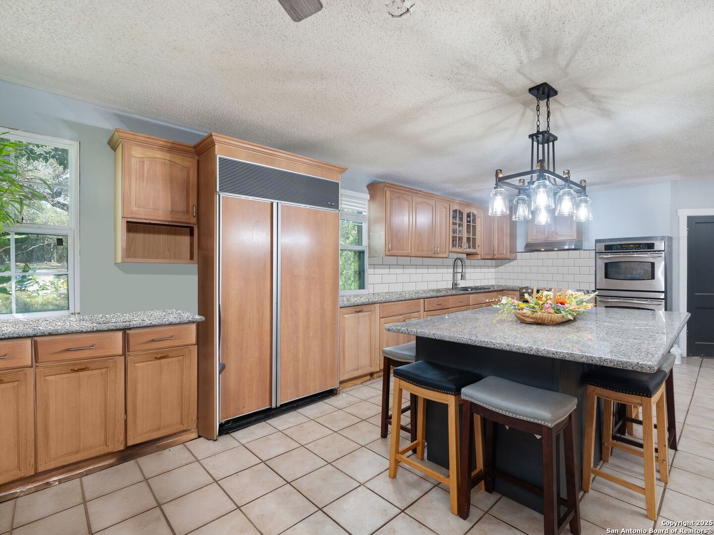 6472 Whitby Road San Antonio, TX 78240 - Photo 4 of 23 a kitchen with stainless steel appliances a dining table chairs and granite counter tops