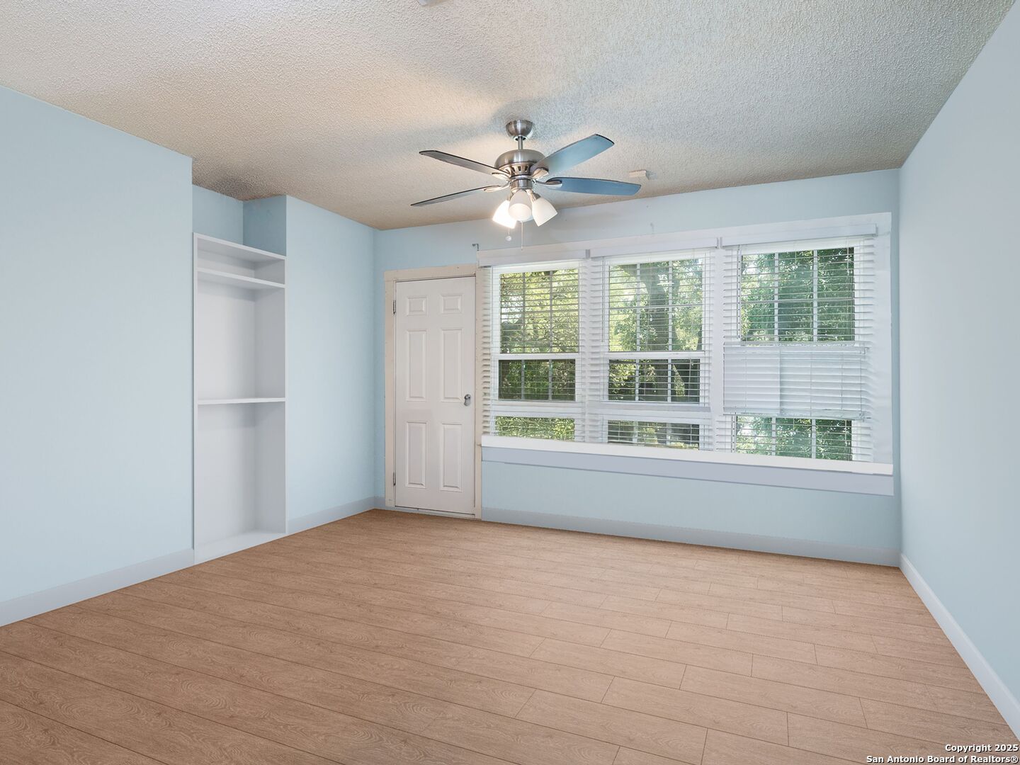 6472 Whitby Road San Antonio, TX 78240 - Photo 5 of 23 a view of an empty room with a window and kitchen view