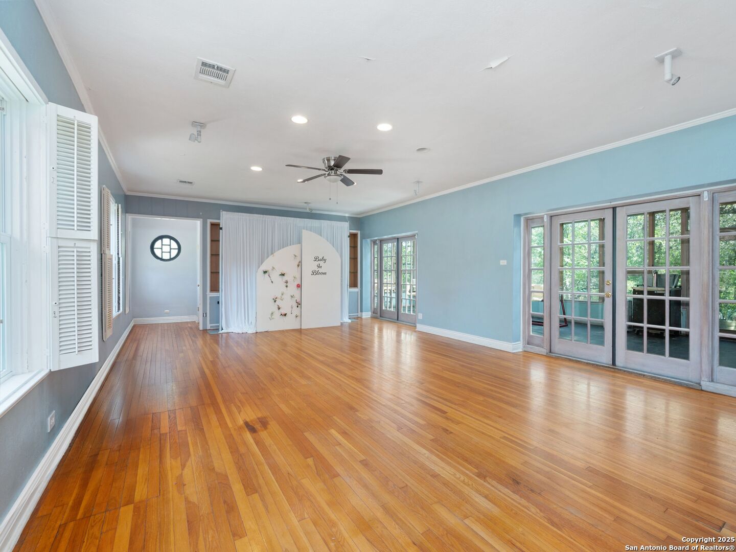 6472 Whitby Road San Antonio, TX 78240 - Photo 10 of 23 a view of an empty room with wooden floor and a window