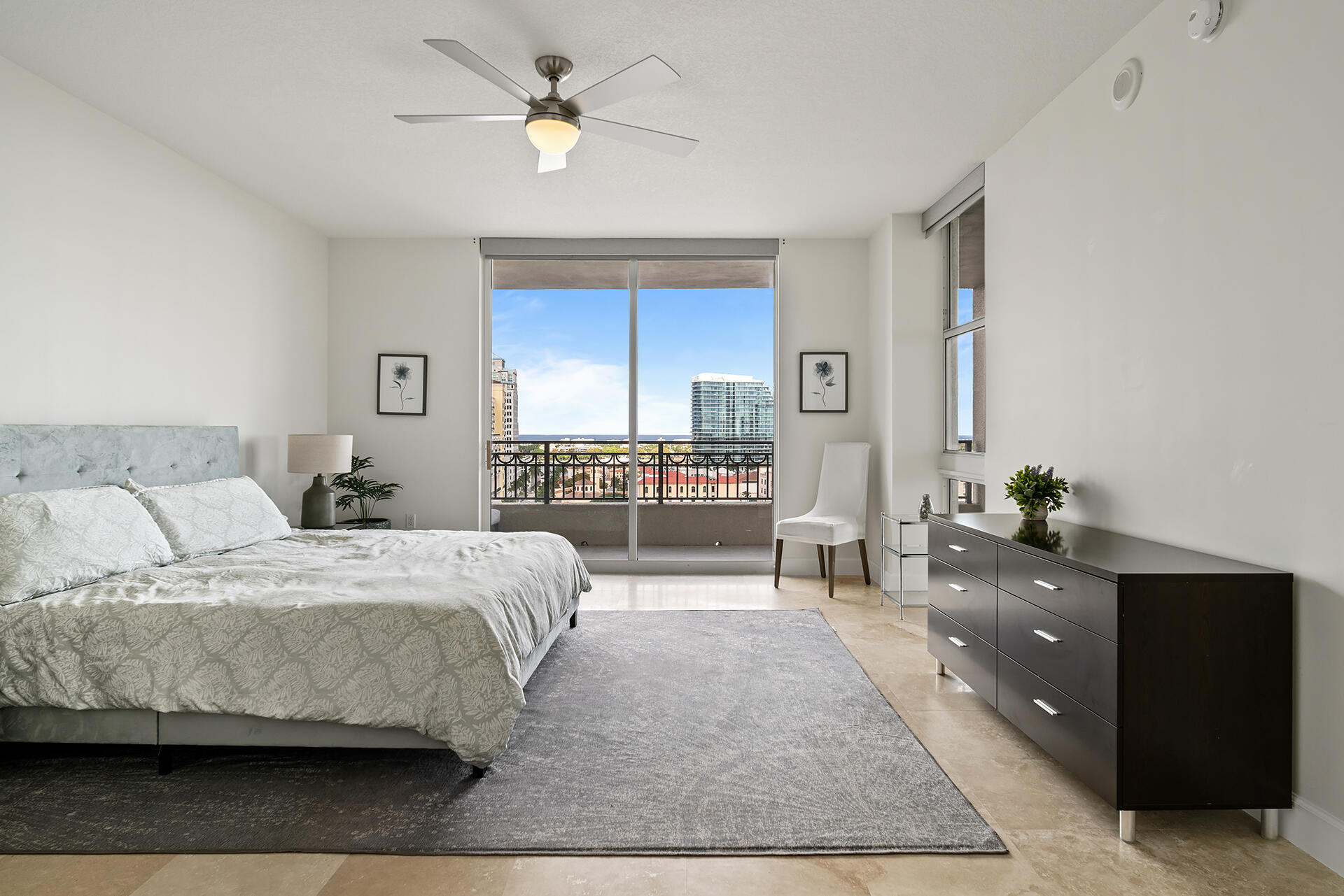 550 Okeechobee Boulevard, Unit 1401 West Palm Beach, FL 33401 - Photo 15 of 46 a bedroom with a large bed and a chandelier