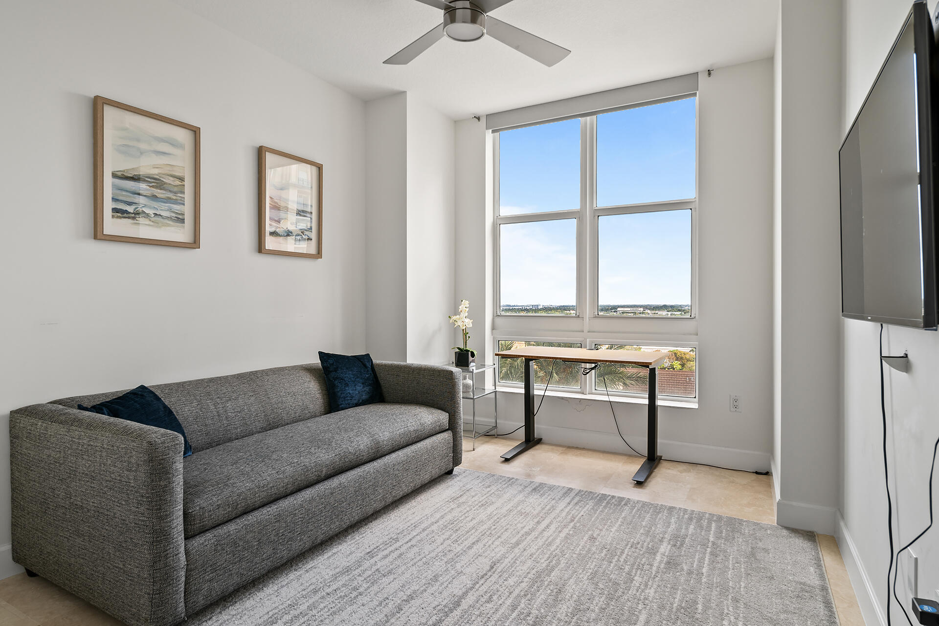 550 Okeechobee Boulevard, Unit 1401 West Palm Beach, FL 33401 - Photo 24 of 46 a living room with a couch and a window