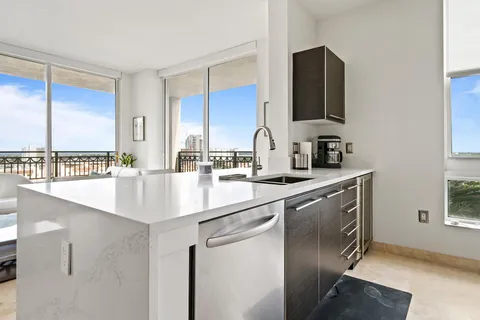a kitchen with stainless steel appliances a sink and a microwave