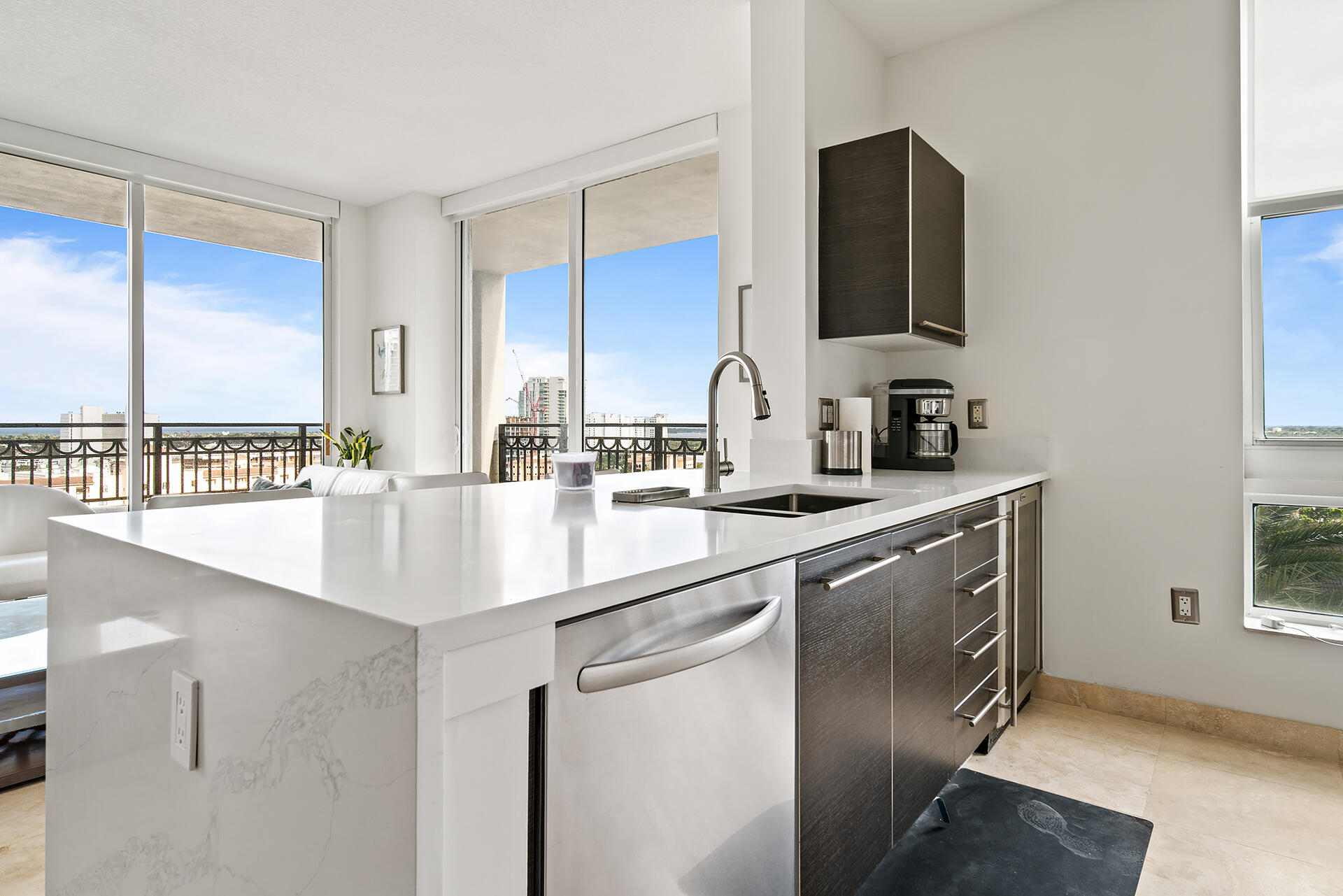 550 Okeechobee Boulevard, Unit 1401 West Palm Beach, FL 33401 - Photo 6 of 46 a kitchen with stainless steel appliances a sink and a microwave