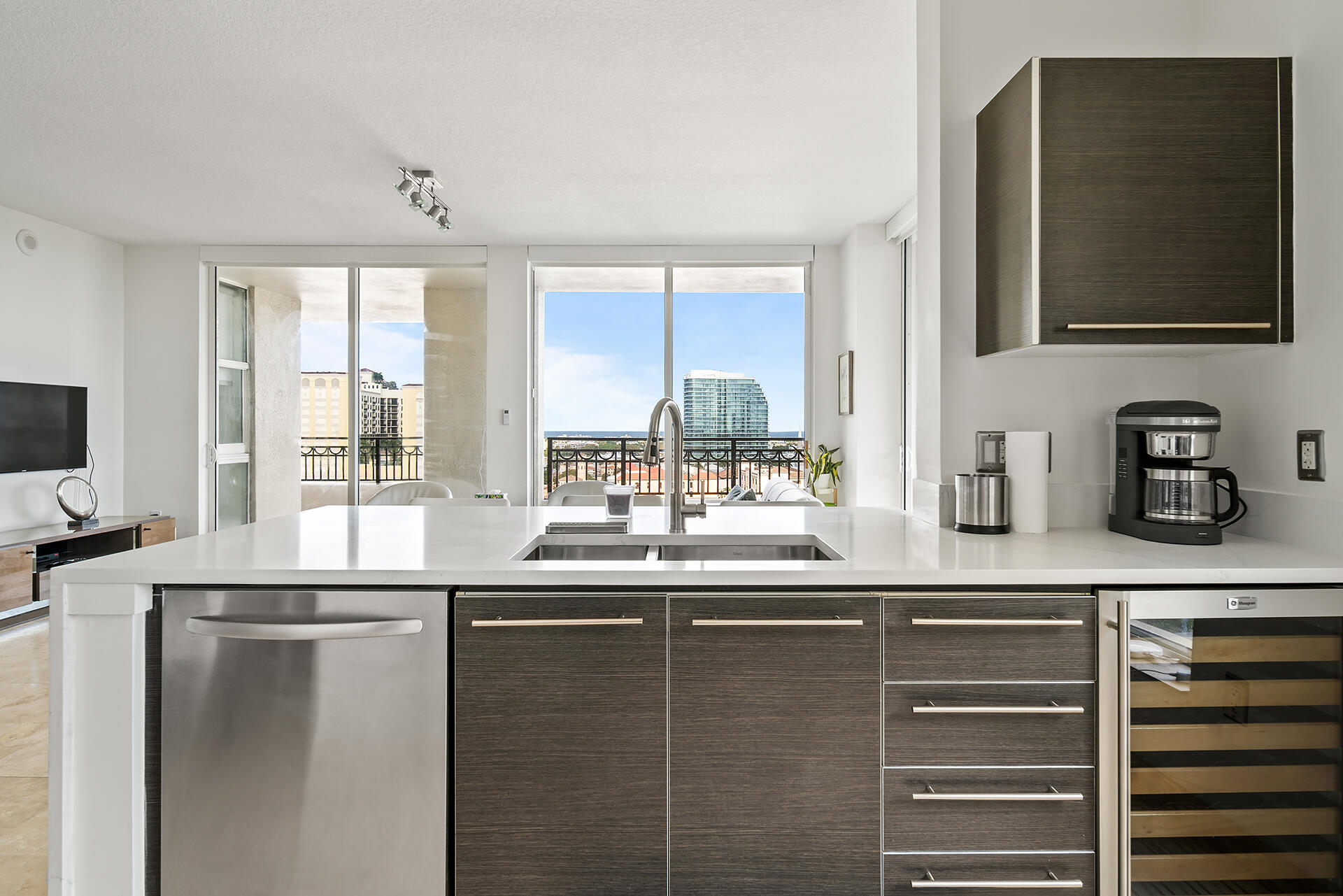 550 Okeechobee Boulevard, Unit 1401 West Palm Beach, FL 33401 - Photo 7 of 46 a kitchen with stainless steel appliances granite countertop a sink and a refrigerator
