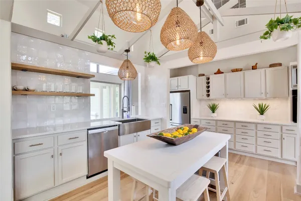 a kitchen with cabinets a sink and appliances