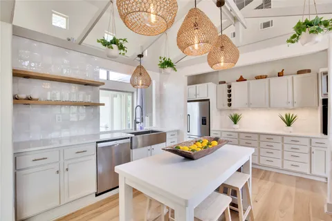a kitchen with cabinets a sink and appliances