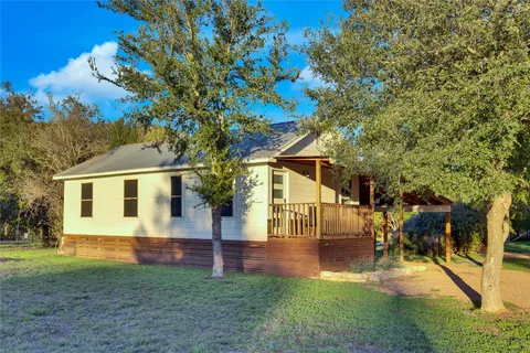a view of backyard of house with green space