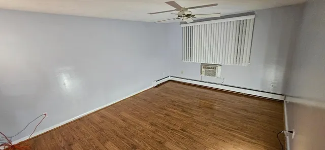 a view of a room with wooden floor
