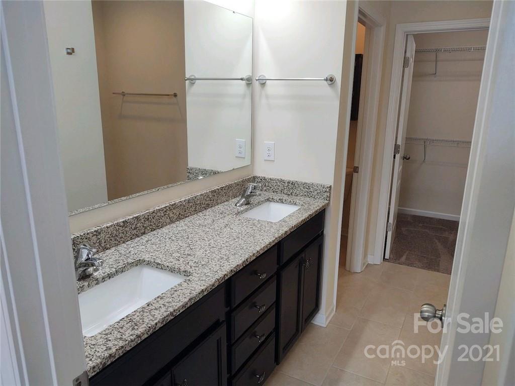 5077 Waterloo Drive Tega Cay, SC 29708 - Photo 7 of 15 a bathroom with a granite countertop sink and a mirror