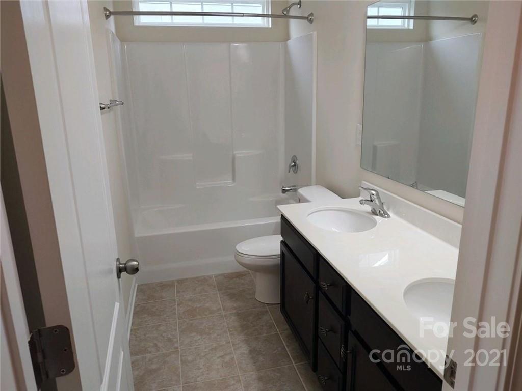 5077 Waterloo Drive Tega Cay, SC 29708 - Photo 8 of 15 a bathroom with a sink a toilet and shower