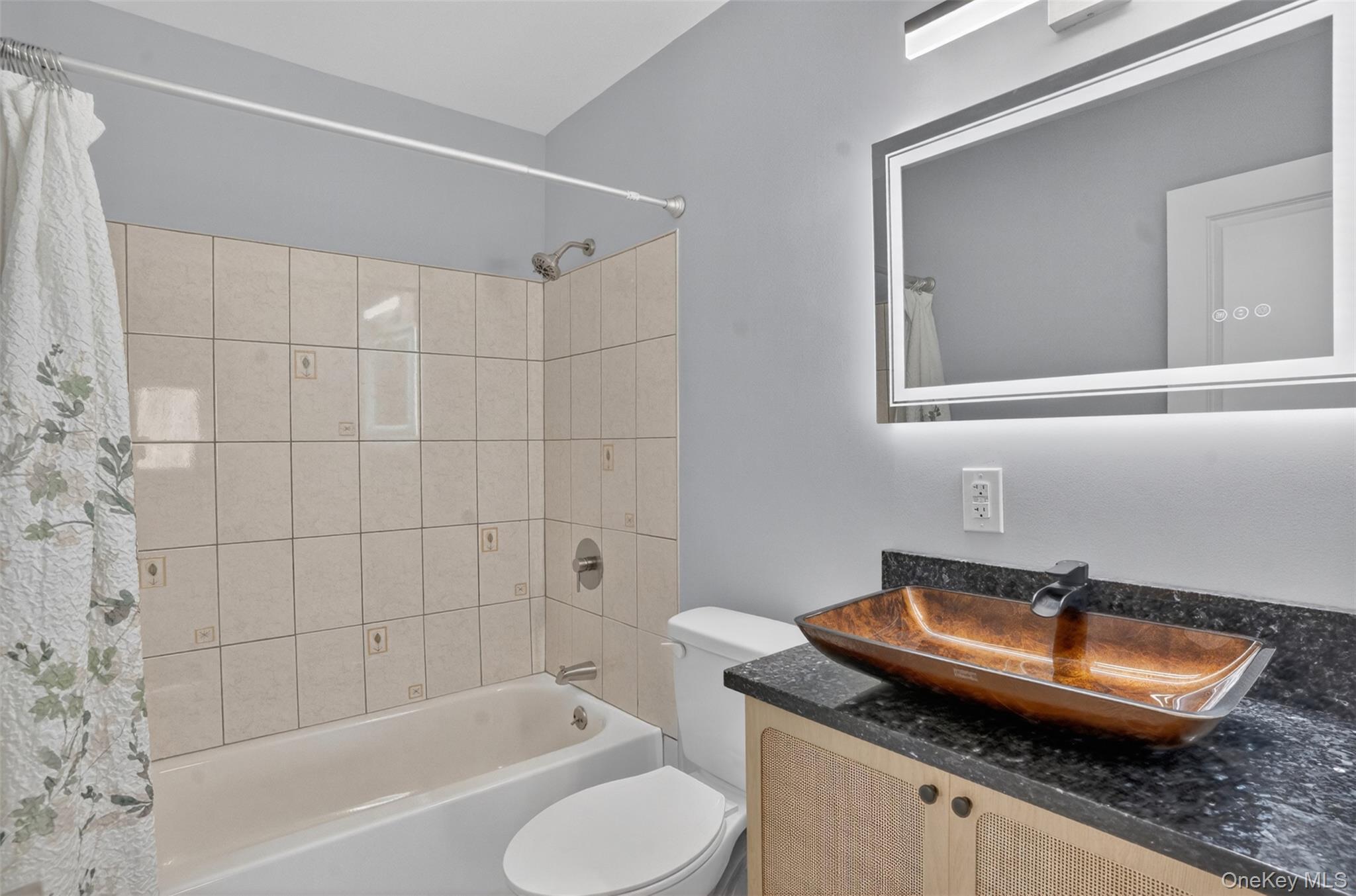 15 North Aspen Road Middletown, NY 10940 - Photo 12 of 16 a bathroom with a granite countertop sink toilet and shower