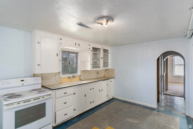 482 West 100 N Street Beaver, UT 84713 - Photo 12 of 41 Kitchen featuring white electric range oven, arched walkways, and white cabinets
