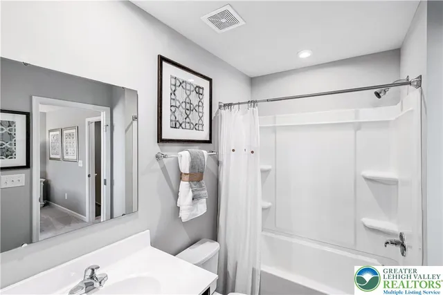 a bathroom with a shower and toilet