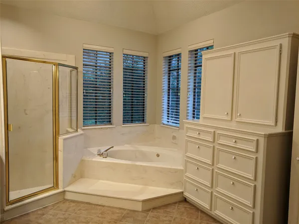 a bathroom with bathtub and window