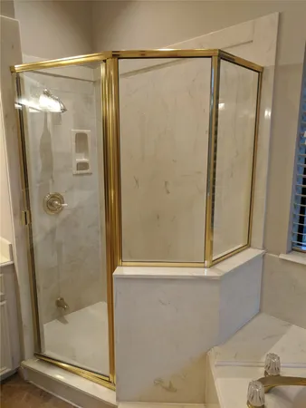 a bathroom with a glass shower door