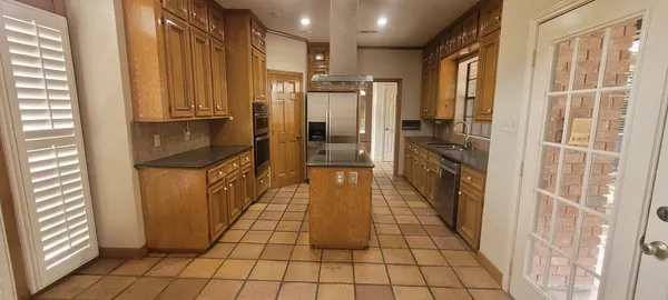a bathroom with a granite countertop shower a sink and a mirror