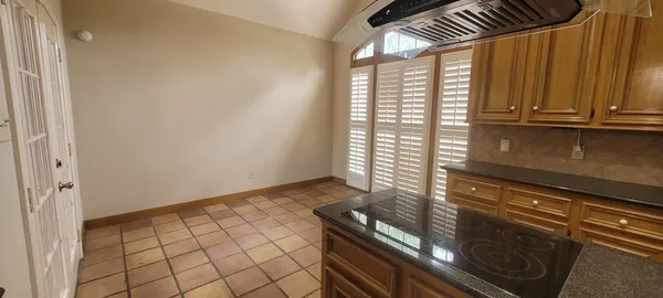 a view of an empty room and wooden floor