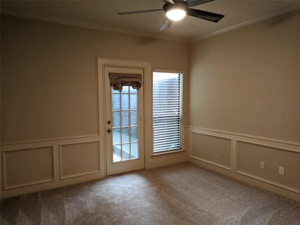 an empty room with chandelier fan