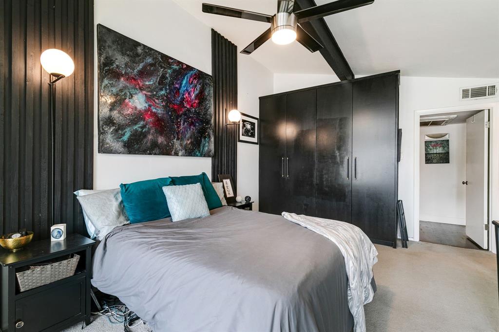 4347 Dickason Avenue, Unit 111 Dallas, TX 75219 - Photo 16 of 37 a bedroom with a bed and painting on the wall