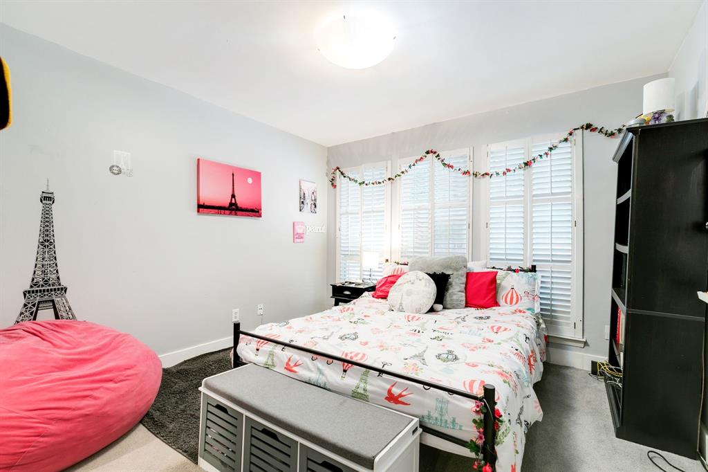 4347 Dickason Avenue, Unit 111 Dallas, TX 75219 - Photo 17 of 37 a bedroom with a bed and a flat screen tv