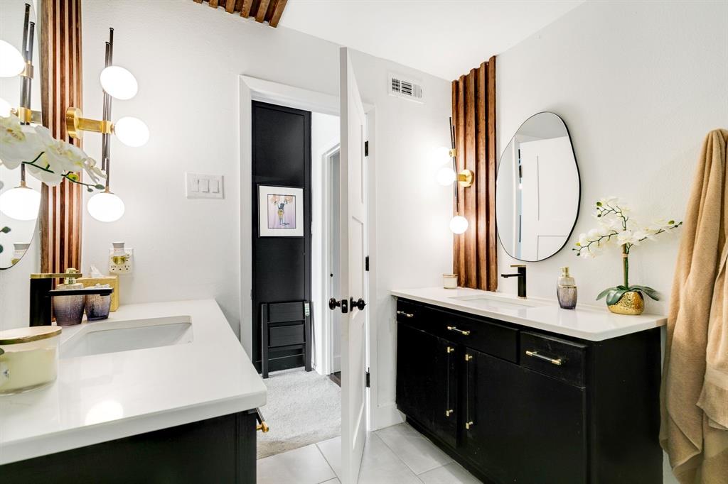 4347 Dickason Avenue, Unit 111 Dallas, TX 75219 - Photo 20 of 37 a bathroom with a sink vanity and a mirror